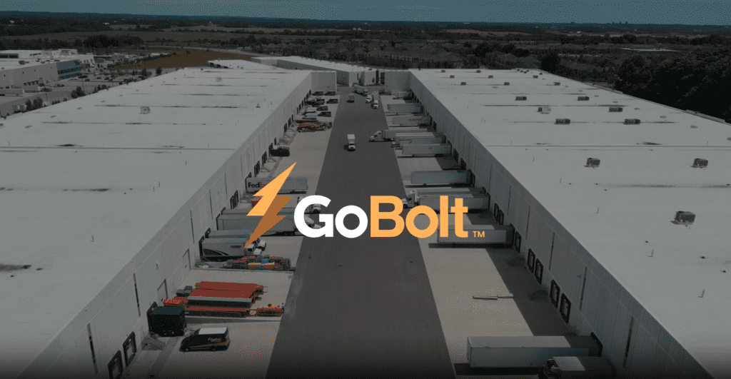 Image of GoBolt warehouse yard with trucks backed up to loading dock doors, overlayed by the GoBolt logo