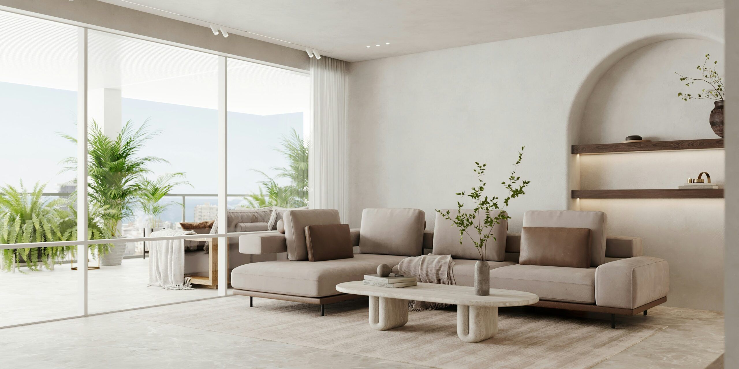 A modern living room with a beige sofa adorned with cushions and a throw blanket.